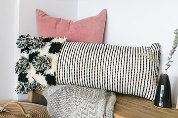 Modern black and white woven lumbar pillow with fringe  on bench, modern home decor, home goods shop