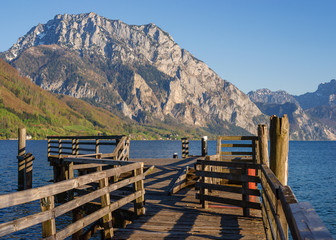 Fototapeta na wymiar Traunsee lake in alps, Austria with pier and mountain in the background. 