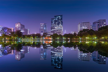 Asia, Thailand, Bangkok cityscape with water reflection from the Lumphini park. 