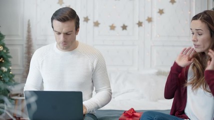 Aggressive couple conflicting in modern house on christmas weekend.