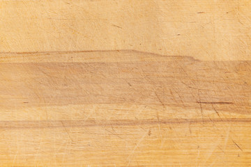 Old scratched wooden cutting board texture background.