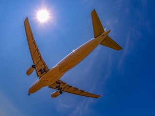 Landing airplane near by sea. blue sky, clear water, amazing view