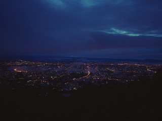 Aerial view of night city light with bokeh from the view point of mountain
