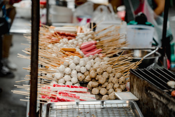Grilled meat ball with sweet spicy sauce on wood dish. Selective focus