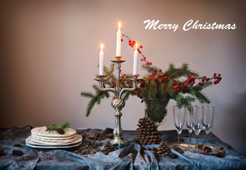 Merry Christmas. Christmas table setting. Champagne glasses and candles on the table