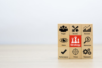 Fototapeta na wymiar Strategy icons on wooden block for success, performance,management,and business growth concept.