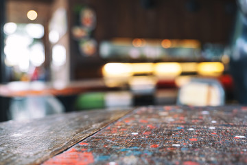 Wooden table and chairs with blurred background in cafe