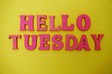 Hello Tuesday alphabet letters on yellow background