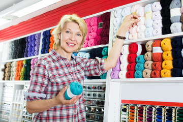 Woman showing colorful yarn balls