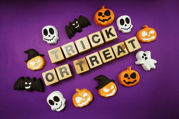 Halloween concept flat lay Trick or Treat alphabet letters on purple background