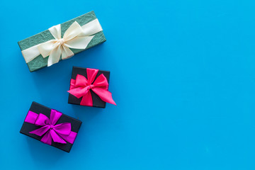 presents in boxes frame on blue background top view copyspace