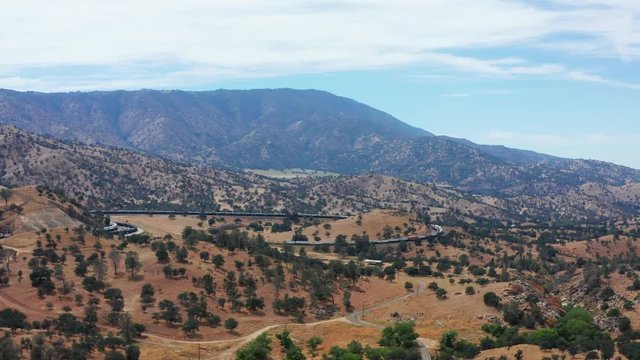 Aerial drone view of train traveling Tehachapi Loop, wide shot