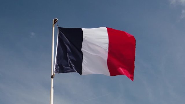 Close view of French flag flapping in the wind in slow motion.