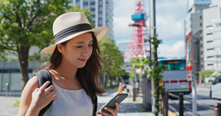 Woman use of mobile phone in the Tokyo city