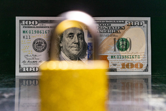 american dollars behind a local on a black background