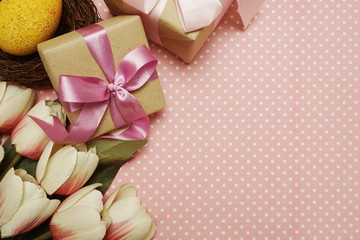 Gift box with roses bouquet with space copy on pink polka dot background