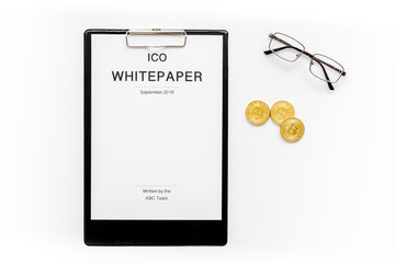 Initial coin offering ICO white paper on white background top view