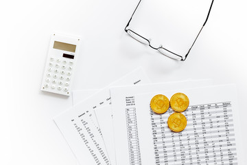 coins, calculation table, office tools for crypto currency concept on white background top view