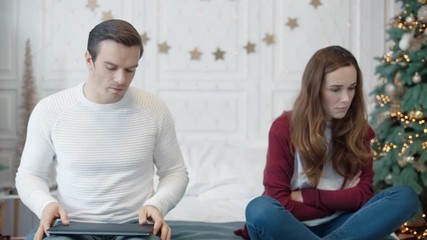 Handsome man saying sorry to woman in luxury house. Sad woman feeling hurt