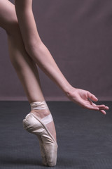 A fragment of the ballerina's arms and legs in pointe shoes. Beautiful composition