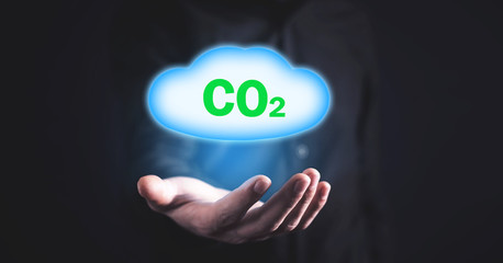 Man holding symbol CO2 with cloud.