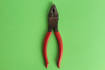old red pliers in colorful background