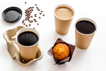 Breakfast with muffin and coffee to-go on white background