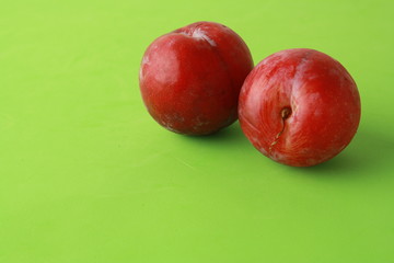 Delicious plums in colorful background
