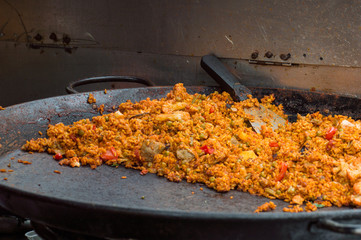 Paella on a big pan in food market stall