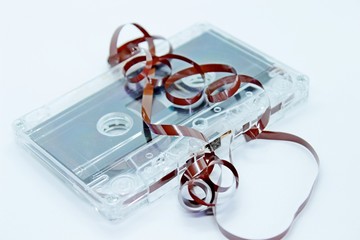 Old audio cassette tape located on a white background