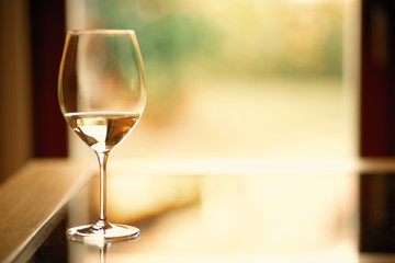 Glass with white wine with blurry background quiet evening of a hard day