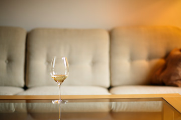 Glass with white wine with blurry background quiet evening of a hard day