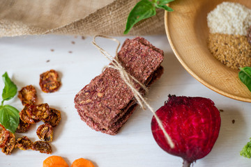 Ukrainian Crispbread  with beetroot and tomato. Healthy diet food. Bread cakes on a white background in the ingredient seasoning.