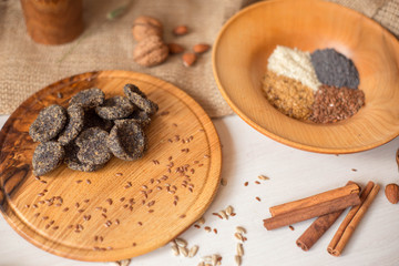 Natural homemade sweets, sugar free, with poppy seeds and sesame seeds. Diet dessert lies on a wooden tray. Healthy lifestyle.