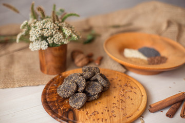 Natural homemade sweets, sugar free, with poppy seeds and sesame seeds. Diet dessert lies on a wooden tray. Healthy lifestyle.