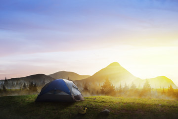 Fototapeta na wymiar Tent in the mountains. Beautiful sunrise landscape