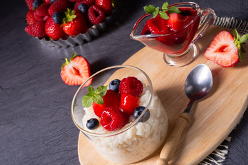 delicious milk rice with different berries and red fruit jelly