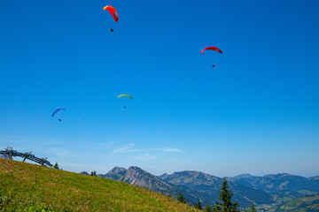 Four paraglider in blue sky