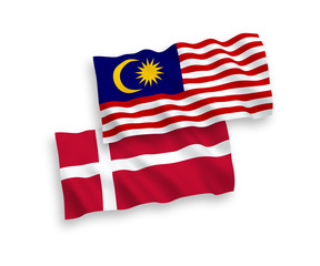 National vector fabric wave flags of Denmark and Malaysia isolated on white background. 1 to 2 proportion.