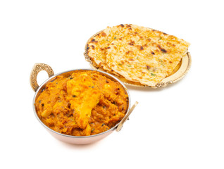 Indian Vegetarian Cuisine Special Sweet And Spicy Paneer Pasanda or Stuffed Paneer Curry, Delicacy Consisting of Stuffed Paneer with Rich Creamy Gravy Served With Garlic Naan on White Background