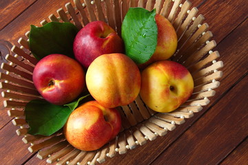 Fresh sweet nectarines on the wooden table