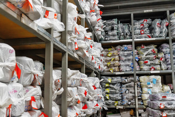 large warehouse of products and bags laid out on shelves,