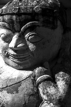Buddhist demon carved out of stone in one of the temples of Bagan in Myanmar. Black and white image