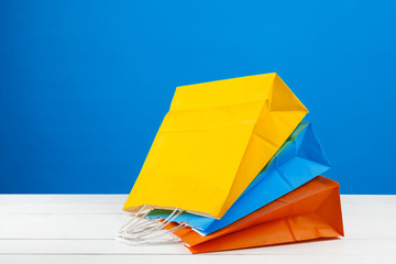 Paper shopping bags with copy space on blue background