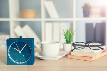 Fototapeta na wymiar Classic vintage alarm clock and coffee cup on wooden background