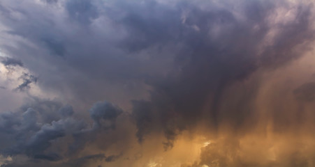 Obraz premium Amazing panoramic storm rainy cloud with orange color from sun