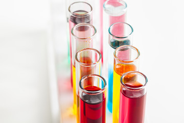 Different laboratory glassware with colored liquids close up