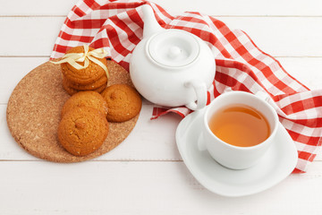 Homemade crunchy cookies and  tea on a wooden table