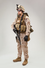 Portrait of a young American US Marine Corps soldier over grey background