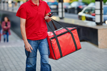 Pizza delivery man carries breakfast, lunch, dinner for consumers. Man of takeaway with red...